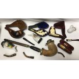 A collection of various pipes to include a Continental Meerschaum pipe with white metal cover,
