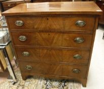 An early 19th Century mahogany and satin strung chest of four long drawers on bracket feet