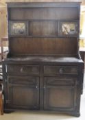 An oak dresser in the Old Charm manner, a similar glazed cabinet,