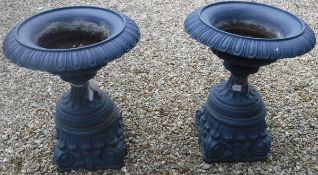 A pair of 19th Century cast iron painted blue urns