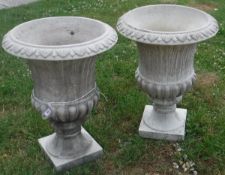 A pair of modern composite stone garden urns of typical form, the insides stamped "H. G. C.