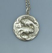 A Georg Jensen pendant depicting two fish (possibly Pisces) with stars and lily,