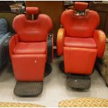 Two vintage barber's chairs with red rexine upholstery