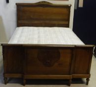 A Continental mahogany bedstead with foliate decoration to head and foot board,