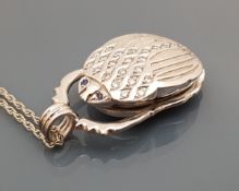 An 18 carat white gold and diamond set pendant in the form of a scarab beetle,