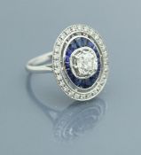 An 18 carat white gold sapphire and diamond set ring, the central stone approx 0.