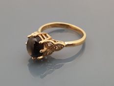 A 9 carat gold dress ring with central star sapphire, flanked by diamond set shoulders,