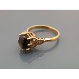 A 9 carat gold dress ring with central star sapphire, flanked by diamond set shoulders,