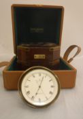 A Baume & Mercier clock as a marine chronometer in polished brass case within a mahogany and brass