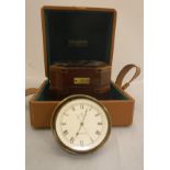 A Baume & Mercier clock as a marine chronometer in polished brass case within a mahogany and brass