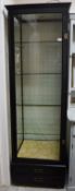 A refurbished Edwardian shop display cabinet of square form with brass fittings