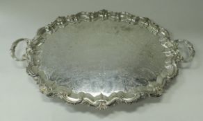 A large silver plated tray in the Rococo taste with all-over scrolling foliate engraved and cast