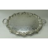 A large silver plated tray in the Rococo taste with all-over scrolling foliate engraved and cast