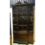 A 20th Century mahogany breakfront bookcase cabinet in the Chippendale manner