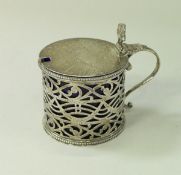 A George III silver drum shaped mustard with pierced decoration and Bristol blue liner (by Thomas