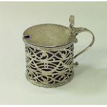 A George III silver drum shaped mustard with pierced decoration and Bristol blue liner (by Thomas