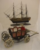 A model of HMS Victory together with a model of a horsedrawn coach and a framed and glazed relief