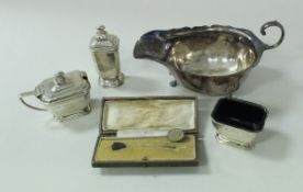A silver sauceboat and a three piece cruet (by Adie Brothers), 6.