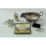 A silver sauceboat and a three piece cruet (by Adie Brothers), 6.