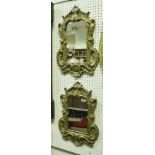 A pair of 19th Century giltwood wall mirrors with carved foliate and C scroll decorated frames