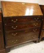 A George III mahogany bureau with sloping fall front over four long drawers,