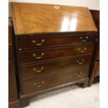 A George III mahogany bureau with sloping fall front over four long drawers,