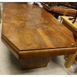 A 1930s Art Deco walnut-veneered elongated octagonal dining table on stepped end pillar supports,