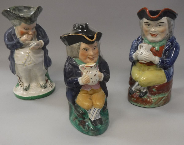 A 19th Century seated Toby jug with tricorn hat and jug of ale,