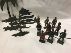 A box containing various painted lead soldiers, Britains and others, together with various trees,