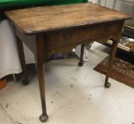 An 18th Century walnut and cross-banded lowboy, the plain top above single drawer to shaped apron,