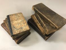 A collection of eleven various 18th Century and later leather bound books to include one volumes