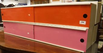 A set of four coloured painted metal storage cabinets with sliding doors