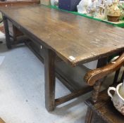 An 18th Century oak refectory-style dining table with plank top with cleated ends above a plain
