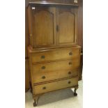 An early 20th Century mahogany bedroom cabinet with two cupboard doors enclosing shelf and two