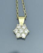 An 18 carat gold diamond set cluster pendant, housed on a 9 carat gold chain, approx 1.