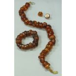 A 9 carat gold mounted amber bead necklace,