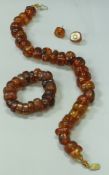 A 9 carat gold mounted amber bead necklace,