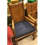 A Victorian oak panel seated hall chair in the Pugin manner the arms with part supports