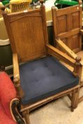 A Victorian oak panel seated hall chair in the Pugin manner the arms with part supports