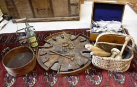 An oak circular table top game with mallets, various sieves, rolling pins, bottle holder etc,