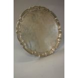 A George V silver salver with piecrust edge and undecorated centre (by Barker Bros Ltd,