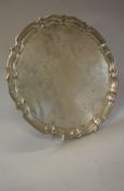 A George V silver salver with piecrust edge and undecorated centre (by Barker Bros Ltd,