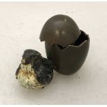 A cold painted bronze as a chick seated beside a broken egg No'd 1523 and inscribed "geschutz"