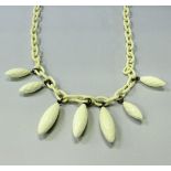 A Giorgio Armani ivory effect resin necklace of large loop and drop form, in Giorgio Armani bag,