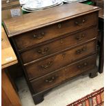 A late George III mahogany chest the plain top with applied moulded edge above four long drawers on