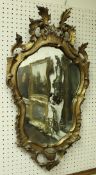An 18th Century shaped giltwood framed wall mirror with scrolling acanthus decoration