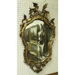 An 18th Century shaped giltwood framed wall mirror with scrolling acanthus decoration