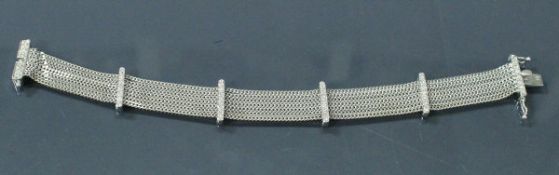 An 18 carat white gold seven strand diamond set bracelet 22 g