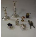 A collection of metal wares to include a pair of plated telescopic lamp candlesticks,