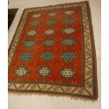 A 20th Century Persian Mahal rug, with repeating stylised lozenge medallions on a red ground,